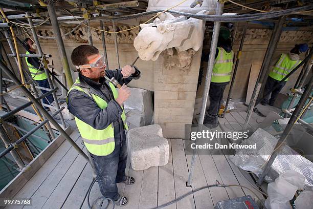 Stone carver Simon Smith puts finishing touches to a gargoyle on Westminster Abbey's Chapter House on April 14, 2010 in London, England. Built in the...