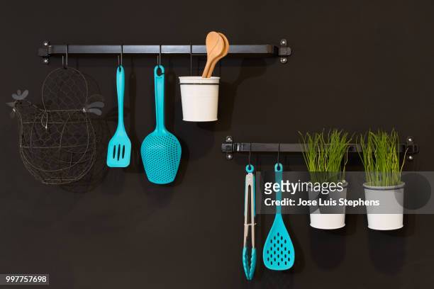 kitchenware hanging in a wall - stephens stock pictures, royalty-free photos & images