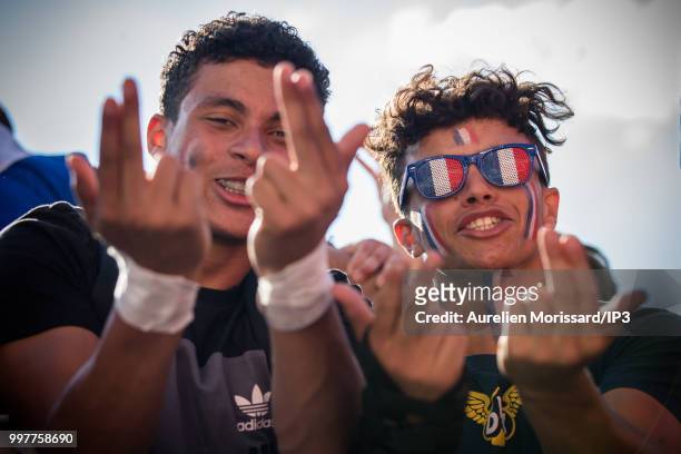 Spectators and supporters of the French team watch the semi final of the 2018 World Cup between France and Belgium on a giant screen at the Hotel de...