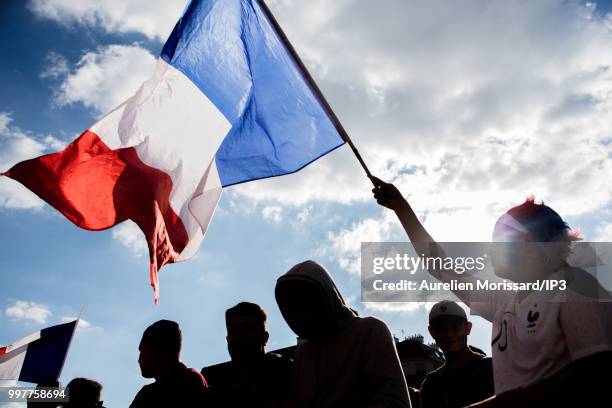 Spectators and supporters of the French team watch the semi final of the 2018 World Cup between France and Belgium on a giant screen at the Hotel de...