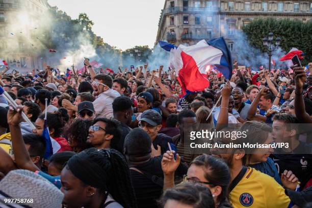 Spectators and supporters of the French team watch the semi final of the 2018 World Cup between France and Belgium on a giant screen at the Hotel de...