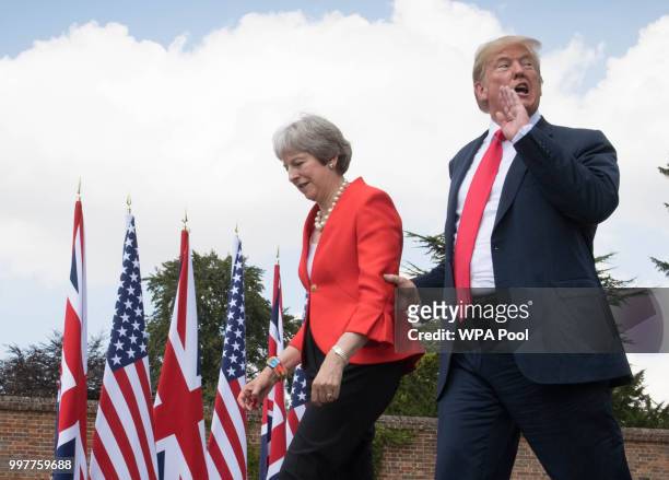 Prime Minister Theresa May and U.S. President Donald Trump make their way to a joint press conference following their meeting at Chequers on July 13,...