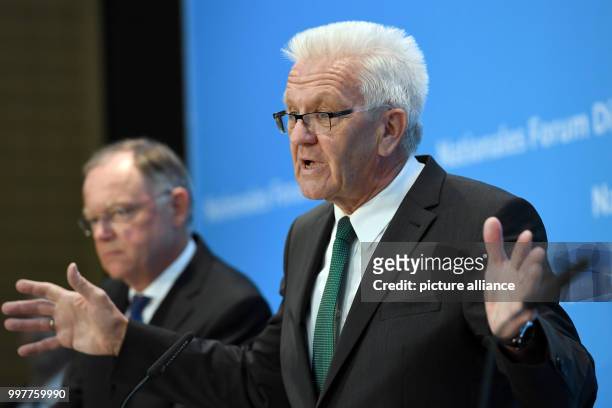 Premier of the German state of Baden-Wuerttemberg Winfried Kretschmann and premier of the German state of Lower Saxony Stephan Weil give a press...