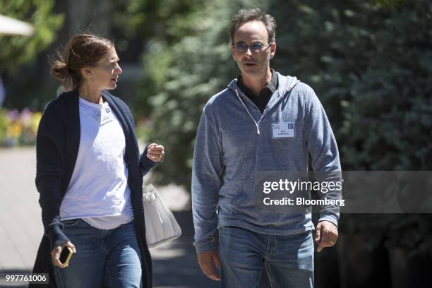 Eric Lefkofsky, co-founder and chairman of Groupon Inc., and Liz Lefkofsky walk the grounds after a morning session at the Allen & Co. Media and...