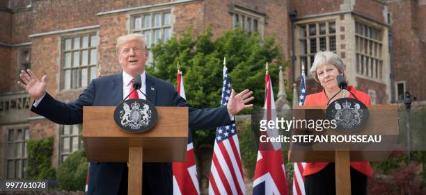 President Donald Trump gestures as he speaks next to Britain's Prime Minister Theresa May during a joint press conference following their meeting at...