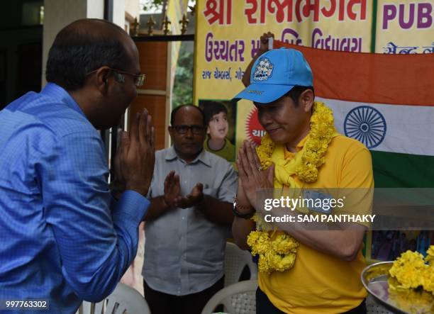 Consul-General of Thai consulate in Mumbai Ekapol Poolpipat is greeted by staff at the Rajabhagat Vidhyalaya school in Ahmedabad on July 13, 2018. -...