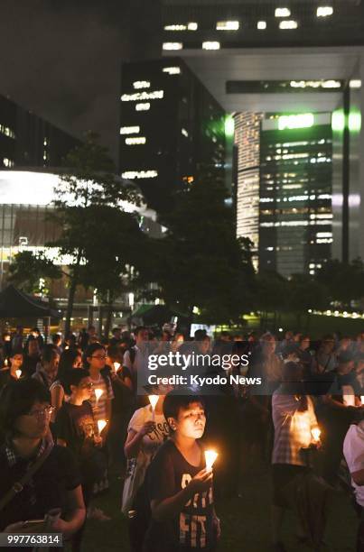 People rally in Hong Kong for a candlelight vigil on July 13 to mark the first anniversary of the death of Nobel Peace Prize laureate and China...