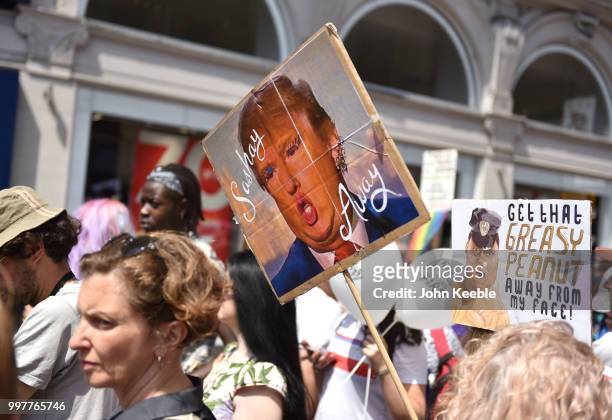 Demonstrators with an anti Trump placards saying "Sashay Away" attend the Drag Protest Parade LGBTQi March against Trump on July 13, 2018 in London,...
