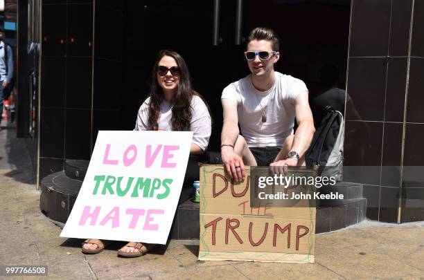 Demonstrators with an anti Trump placards saying "Love Trumps Hate" and Dump The Trump" attend the Drag Protest Parade LGBTQi March against Trump on...