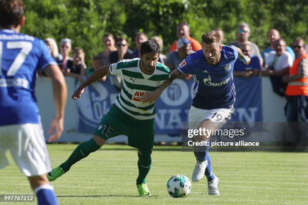 Eibar's Jose Angel Valdes and Schalke's Guido Burgstaller vie for the ball during the international club friendly soccer match between FC Schalke 04...