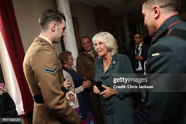 Camilla, Duchess of Cornwall speaks to Corporal Jack Stock during a visit to New Normandy Barracks on July 12, 2018 in Aldershot, England.