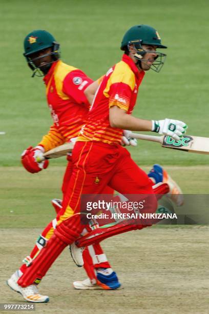 Zimbabwe's batsman Ryan Murray runs between the wickets with teammate Tendai Chatara during the first one day international cricket match between...