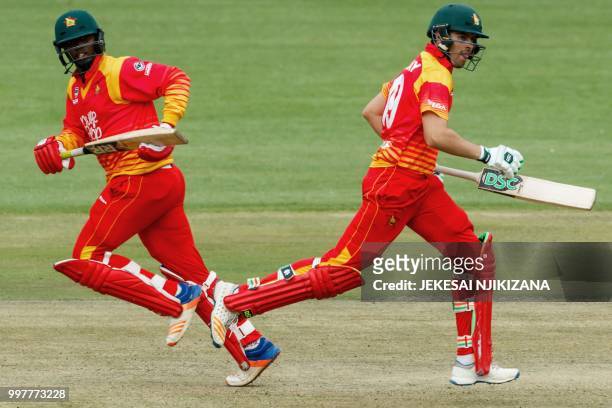 Zimbabwe's batsman Ryan Murray runs between the wickets with teammate Tendai Chatara during the first one day international cricket match between...