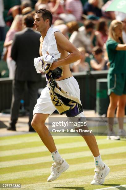 John Isner of The United States leaves Centre Court during a break in his Men's Singles semi-final match against Kevin Anderson of South Africa...