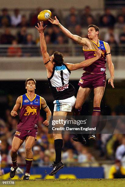 Beau McDonald of Brisbane goes for the ball against Matthew Primus of Port Adelaide during the AFL Qualifying final match between the Brisbane Lions...
