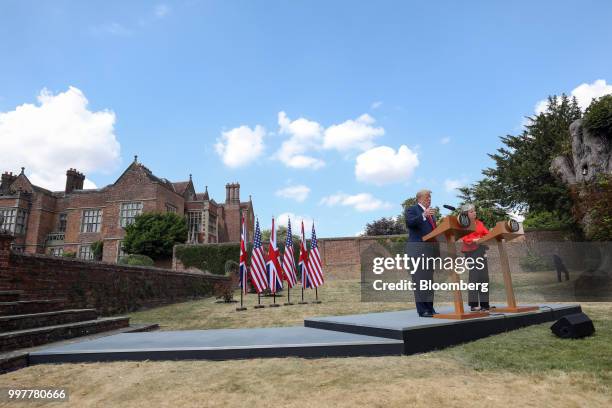 President Donald Trump, left, speaks alongside Theresa May, U.K. Prime minister, right, during a joint news conference at Chequers in Aylesbury,...