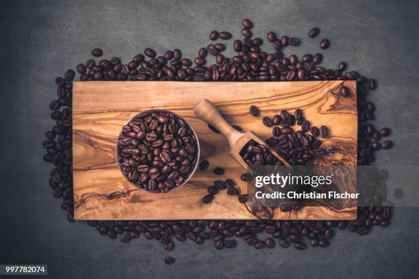 coffee beans on an olive wood board - wood family crest stock pictures, royalty-free photos & images