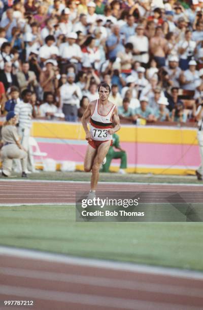 Portuguese long distance runner Carlos Lopes competes for the Portugal team to finish in first place to win the gold medal in the Men's marathon...