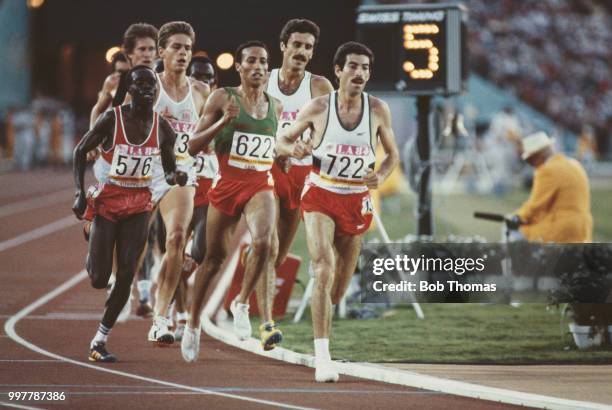 View of athletes competing in the final of the Men's 5000 metres event with, from left, Charles Cheruiyot of Kenya, Tim Hutchings of Great Britain,...