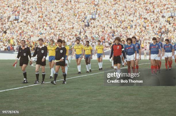 The France and Brazil football teams walk on to the pitch prior to competing in the final of the football tournament at the 1984 Summer Olympics at...