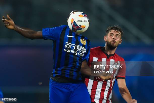 Richmond Boakye of Jiangsu Suning and Jack Stephens of Southampton compete for the ball during the 2018 Clubs Super Cup match between Southampton FC...