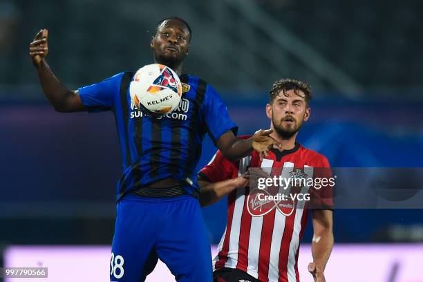 Richmond Boakye of Jiangsu Suning and Jack Stephens of Southampton compete for the ball during the 2018 Clubs Super Cup match between Southampton FC...