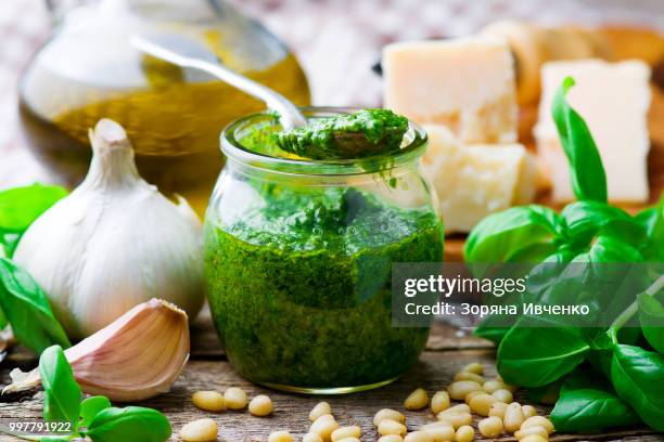 pesto sauce in a glass jar - pesto stock pictures, royalty-free photos & images