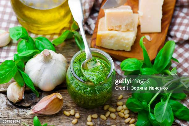 pesto sauce in a glass jar - pesto stock pictures, royalty-free photos & images