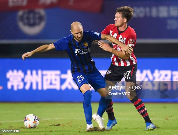Gabriel Paletta of Jiangsu Suning and Sam Gallagher of Southampton compete for the ball during the 2018 Clubs Super Cup match between Southampton FC...