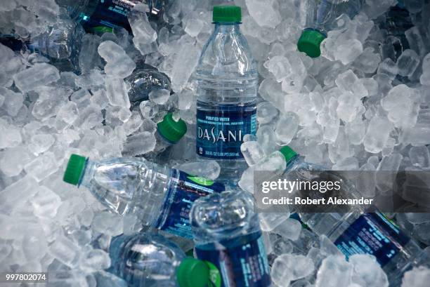 Tub filled with ice and plastic bottles of Dasani purified bottled water being given away at a Fourth of July holiday event in Santa Fe, New Mexico....