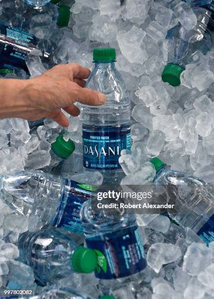 Tub filled with ice and plastic bottles of Dasani purified bottled water being given away at a Fourth of July holiday event in Santa Fe, New Mexico....