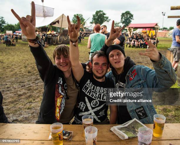 Erik , Felix and Jona are having a beer and show the sign of the horns on the grounds of Wacken Festival in Wacken, Germany, 3 August 2017. Wacken...