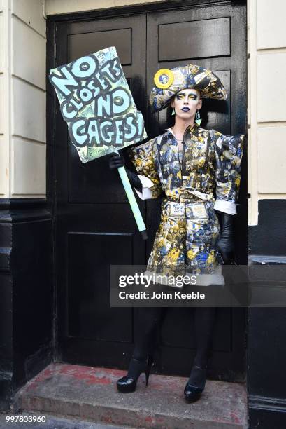 Drag Queen Cheddar Gorgeous holding a placard saying "No closets no cages" attends the Drag Protest Parade LGBTQi+ March against Trump on July 13,...