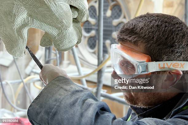 Stone carver Simon Smith puts finishing touches to a gargoyle on Westminster Abbey's Chapter House on April 14, 2010 in London, England. Built in the...