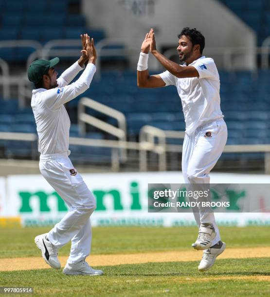 Mehidy Hasan Miraz and Abu Jayed of Bangladesh celebrate the dismissal of Shimron Hetmyer of West Indies during day 2 of the 2nd Test between West...