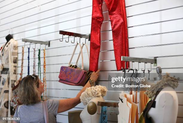 Woman looks at pants made out of a coated cotton remnant by Diana Jaye Coluntino at the opening of UMass Lowell's Fabric Discovery Center in Lowell,...