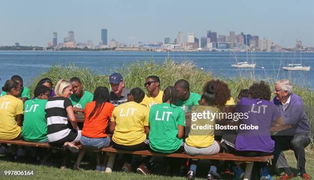 Boston Mayor Martin J. Walsh, seated wearing blue New England Patriots hat, visits to teach a civics class to a group of 15-18-year-olds who have...