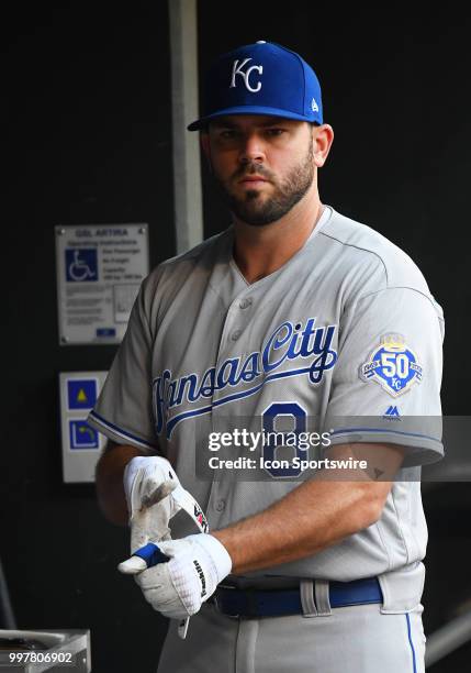 Kansas City Royals First base Mike Moustakas removes his batting gloves in the dugout during a MLB game between the Minnesota Twins and Kansas City...