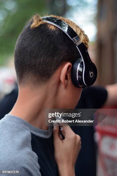 Teenage boy wears Beats by Dr. Dre headphones in Santa Fe, New Mexico.