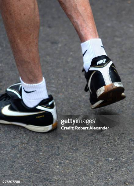 Man wears a pair of Nike Tiempo shoes and Nike socks in Santa Fe, New Mexico.