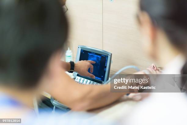 medical doctor student learning to use ultra sound scanner machine. - ultra foto e immagini stock