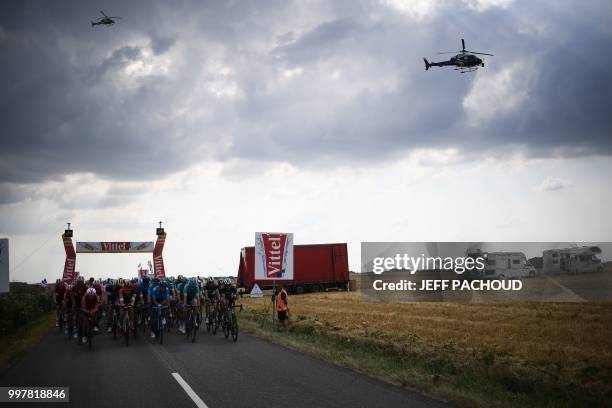 The pack rides under the banner signaling the last 20 kilometers during the seventh stage of the 105th edition of the Tour de France cycling race...