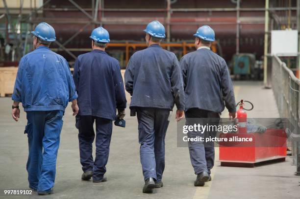 Workers in the factory of MV Werften, a company that recently completed a number of river cruise ships for export to the American company...