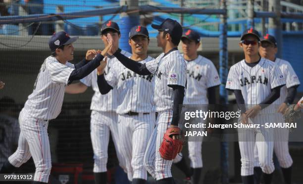 Hiromi Ito of Japan celebrates with team mates after the ninth inning during the Haarlem Baseball Week match between Japan and Italy at Pim Mulier...