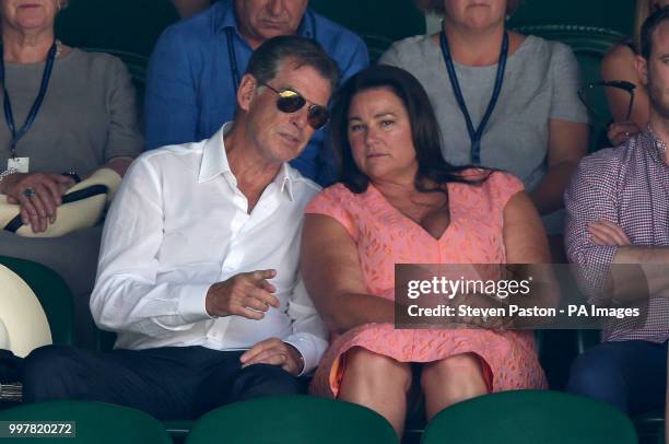 Pierce Brosnan and Keely Shaye Smith in the stands on day eleven of the Wimbledon Championships at the All England Lawn Tennis and Croquet Club,...