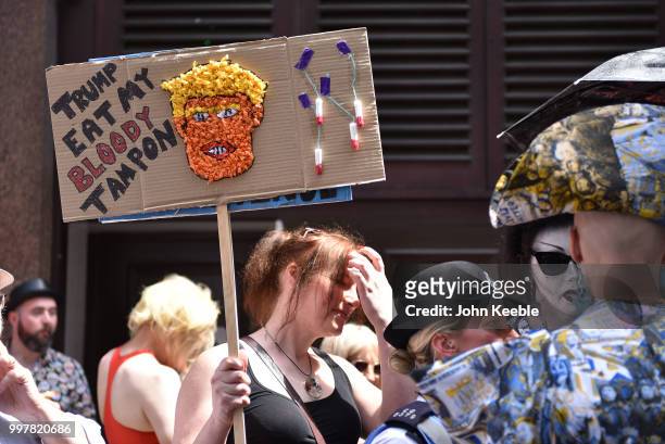 Demonstrator with an anti Trump placard saying "Trump eat my bloody tampon" attends the Drag Protest Parade LGBTQi March against Trump on July 13,...