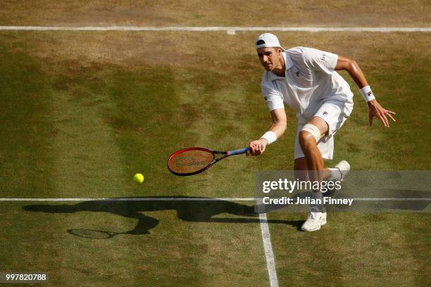 John Isner of The United States returns against Kevin Anderson of South Africa during their Men's Singles semi-final match on day eleven of the...