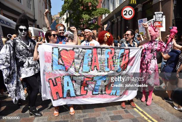 Demonstrators with an anti Trump banner saying "Love America hate Trump" attend the Drag Protest Parade LGBTQi March against Trump on July 13, 2018...