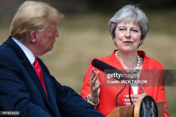 President Donald Trump listens as Britain's Prime Minister Theresa May speaks during a press conference following their meeting at Chequers, the...