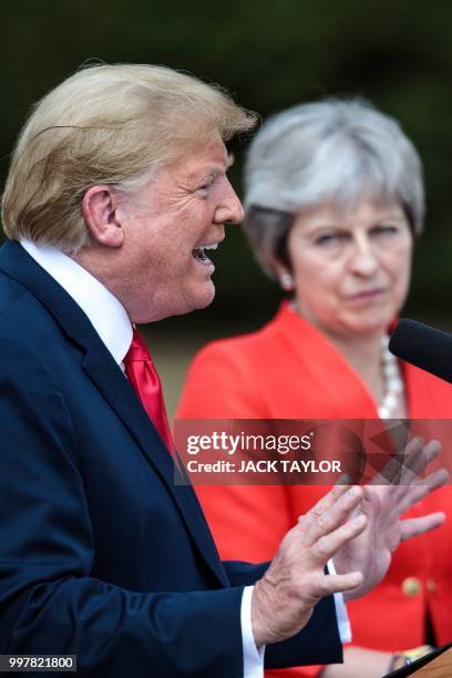 President Donald Trump gestures as he speaks next to Britain's Prime Minister Theresa May during a press conference following their meeting at...